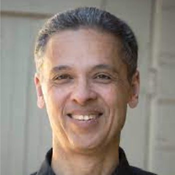 A man poses for a close-up photo outdoors.