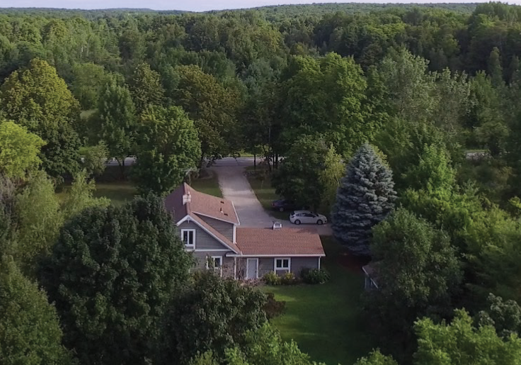 a small house on door county, painted gray