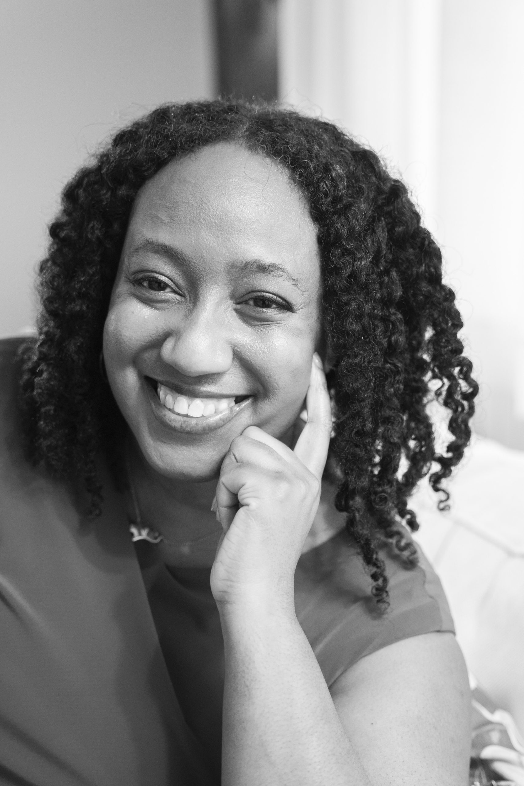 image of a smiling black woman with twisted braids